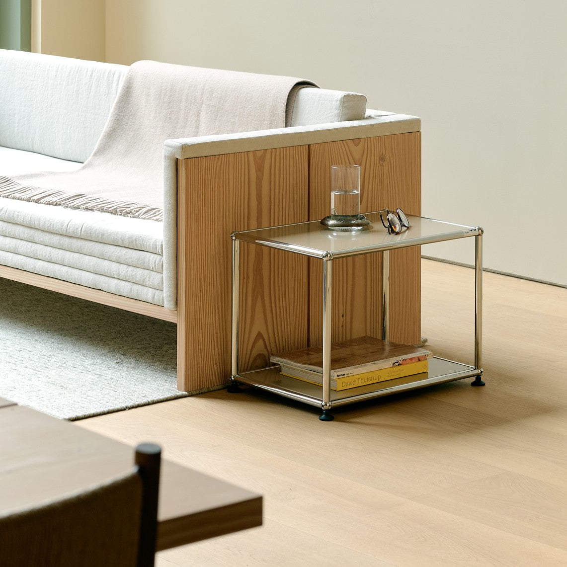 USM Haller side table M22 next to a sofa